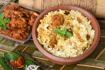 Chicken biryani. Spicy Indian Malabar biryani or Hydrabadi biryani, Dum Biriyani,  fish and rice. pulao basmati rice, spicy mixed rice dish with meat curry for Ramadan Kareem, Eid