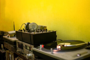 dj headphones in the foreground. Soundboard. Turntable