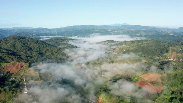 Backward flight over the Constanza valley, Dominican Republic, cool day, clear sky
