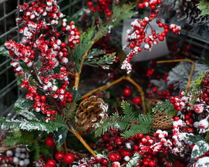 Christmas decoration background. Holly branches with berries in hoarfrost. Christmas symbols snow,...