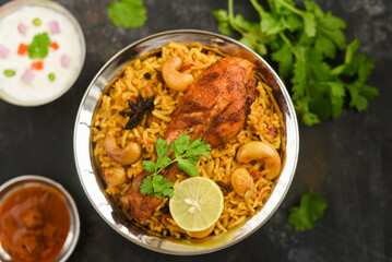 Chicken biryani. Spicy Indian Malabar biryani or Hydrabadi biryani, Dum Biriyani,  fish and rice. pulao basmati rice, spicy mixed rice dish with meat curry for Ramadan Kareem, Eid