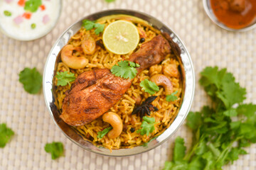Chicken biryani. Spicy Indian Malabar biryani or Hydrabadi biryani, Dum Biriyani,  fish and rice. pulao basmati rice, spicy mixed rice dish with meat curry for Ramadan Kareem, Eid