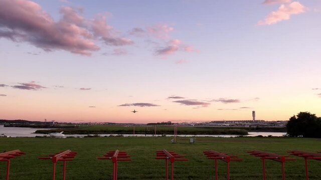 Washington National Airport at sunset. Video shows Potomac river, the tower, runway, terminal buildings and an airplane taking off and going up.