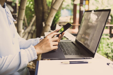 businesswoman hands searching for data on Smart phone  with analyzing tax at his workplace.concept