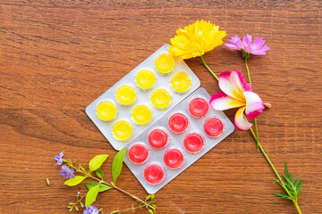 herbal cough sore throat pastille extract herbal for health care with flowers arrangement flat lay style on background wooden