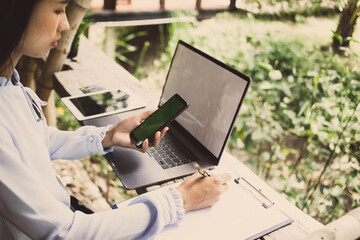 businesswoman hands searching for data on Smart phone  with analyzing tax at his workplace.concept