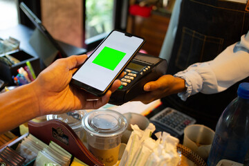 Employees are scanning QR codes to pay for food in the coffee shop.concept