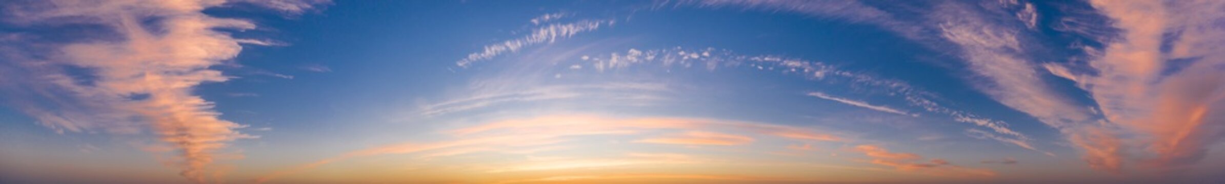 Colorful sky with cirrus clouds during dawn. High resolution panorama. View from drone