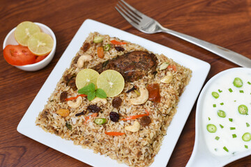 Chicken biryani. Spicy Indian Malabar biryani or Hydrabadi biryani, Dum Biriyani,  fish and rice. pulao basmati rice, spicy mixed rice dish with meat curry for Ramadan Kareem, Eid
