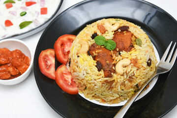Chicken biryani. Spicy Indian Malabar biryani or Hydrabadi biryani, Dum Biriyani,  fish and rice. pulao basmati rice, spicy mixed rice dish with meat curry for Ramadan Kareem, Eid
