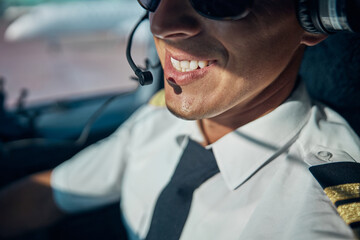 Smiling young male pilot enjoying his work in skies © Svitlana