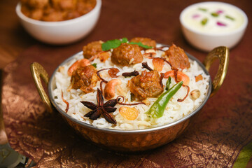 Fototapeta na wymiar Veg biryani or soya biryani. Spicy Indian Malabar biryani or Hydrabadi biryani, Dum Biriyani, pulao, pulav, pilaf, basmati rice, spicy mixed rice dish with meat curry for Ramadan Kareem, Eid