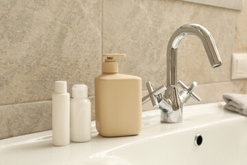 Fototapeta na wymiar Sink and personal hygiene accessories in bathroom