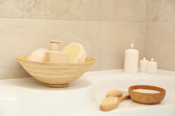 Obraz na płótnie Canvas Bath with personal hygiene accessories in light beige bathroom
