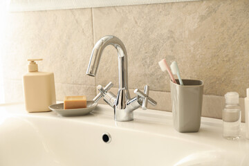 Fototapeta na wymiar Sink and personal hygiene accessories in bathroom
