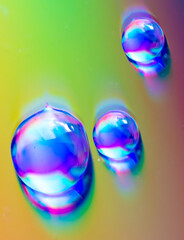 Water drops on a rainbow background.