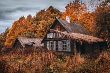 Wooden rustic houses in old village. Cloudy autumn day in a countryside mill village.