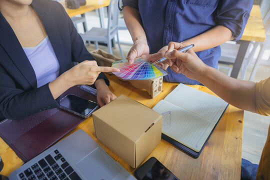 Team designer working graphic packaging design with color chart and materials meeting brainstorm for new project.