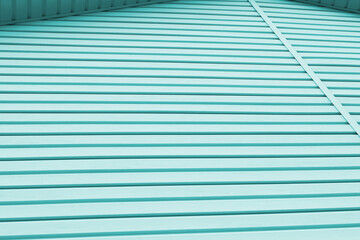 Striped plastic siding surface. Construction and renovation of buildings. Tinted light aquamarine or turquoise background or wallpaper. Building materials or technologies