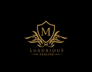 Obraz premium Classic Shield Logo With M Letter. Elegant Shield badge With Floral Shape perfect for fashion, Boutique, Jewelry, Hotel, Restaurant.