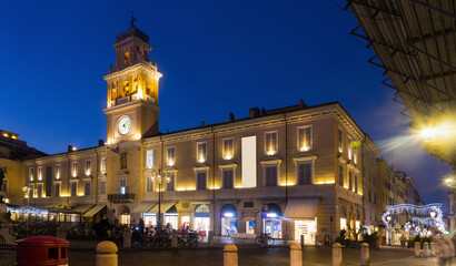 Fototapeta na wymiar Picture of Parma city hall illuminated at evening, Garibaldi square, Italy .