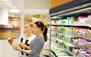 ,Woman choosing a dairy products at supermarket