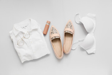 Stylish female clothes and accessories on white background