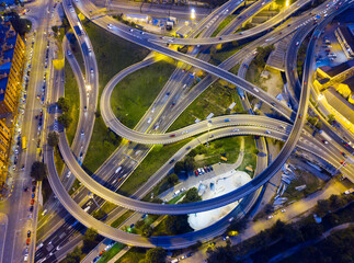 Busy highway junction with lights at night, aerial view