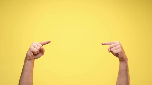 Two Arms Pointing At Each Other And Giving A Thumbs Up On Yellow Background