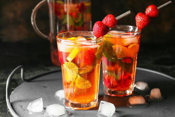 Glasses of tasty strawberry cocktail mojito on table