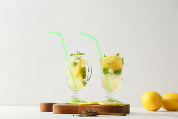 Cups of tasty cold ice tea on table