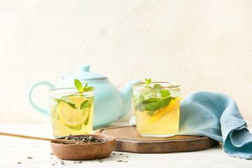 Glasses of tasty cold ice tea on table