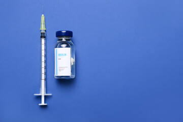 Bottle of insulin with syringe on color background. Diabetes concept