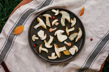 Sliced fresh mushrooms lie on a plate, preparation of mushroom dishes. Copy space, background for recipes of vegan dishes Flat lay