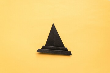 Fototapeta premium Step by step photo instruction how to make origami paper hat. Halloween hat of witch. Simple diy with kids children's concept.