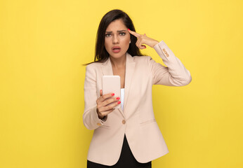 young businesswoman in pink suit pointing fingers to head