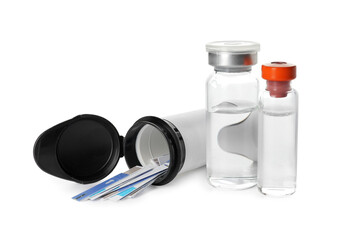 Bottles of insulin and test strips for glucometer on white background. Diabetes concept