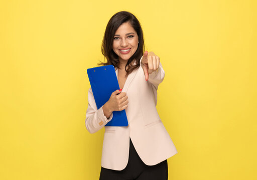 Young Woman In Pink Suit Pointing Finger And Smiling