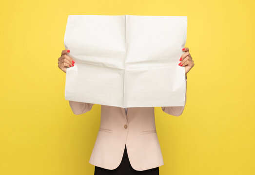 young businesswoman in pink suit covering face