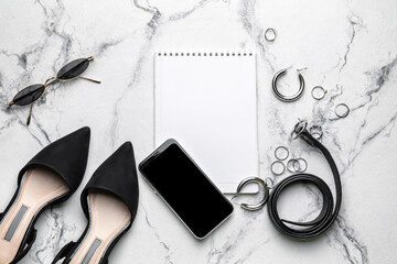 Composition with empty notebook, mobile phone and female accessories on white background
