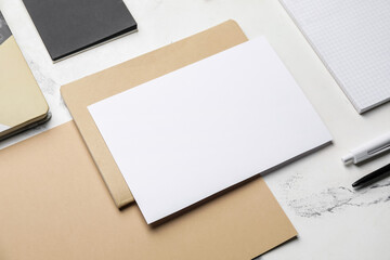 Composition with blank card and stationery on white background