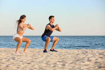 Sporty young couple training on sea beach
