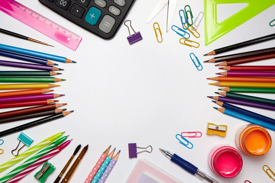Colored school supplies for learning on a white background. Back to school. Pens, rulers, pencils and paper clips. Flat lay, top view, copy space