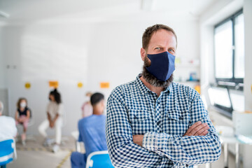 Portrait of mature man with face mask waiting, coronavirus, covid-19 and vaccination concept.