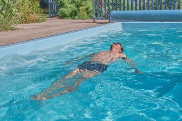 A man swims in a pool in the courtyard