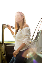 Pretty middle aged woman at the steering wheel of her car