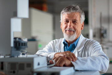 Senior chemistry professor/doctor carrying out research experiments  in an analytical chemistry lab (color toned image)