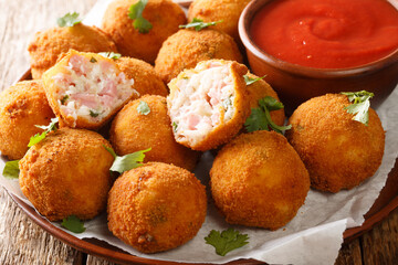 American Sauerkraut and Ham Balls served with ketchup close-up in a plate on the table. Horizontal