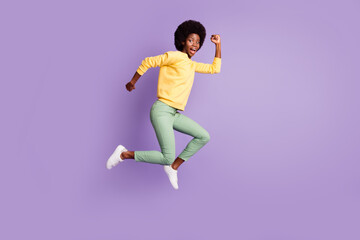 Fototapeta na wymiar Full length profile side photo of crazy afro american girl jump run copyspace isolated over purple color background