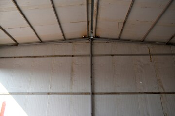Sandwich panel. Industrial warehouse construction and interior view of the roof ceiling structure. Muscat